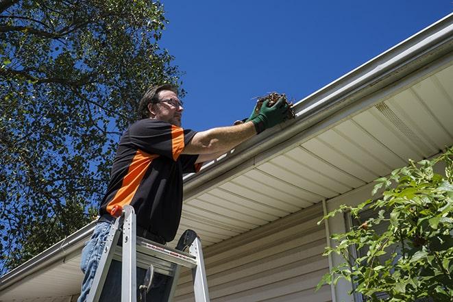 a damaged gutter being repaired by a professional in Mercer Island