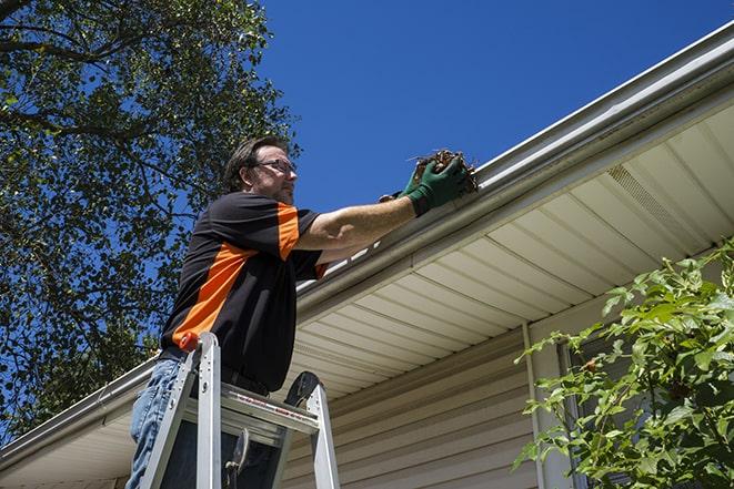 repairman working on a broken rain gutter in Tracyton, WA